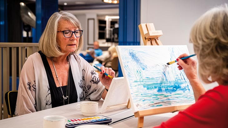 Two women painting in the Craft Room on Spirit of Adventure